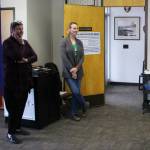 Seward City Clerk Brenda Ballou (left) and poll worker Vanessa Verhey stand near a ballot tabulator during a special election on Tuesday, May 2, 2023, in Seward City Hall in Seward, Alaska. (Ashlyn OHara/Peninsula Clarion)