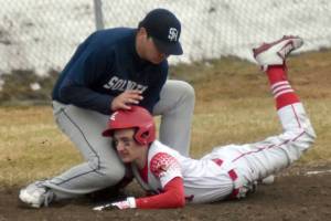 Soldotna's Sage Cruz tags out Kenai Central's Owen Whicker on Tuesday, May 2, 2023, at the Kenai Little League Fields in Kenai, Alaska. (Photo by Jeff Helminiak/Peninsula Clarion)