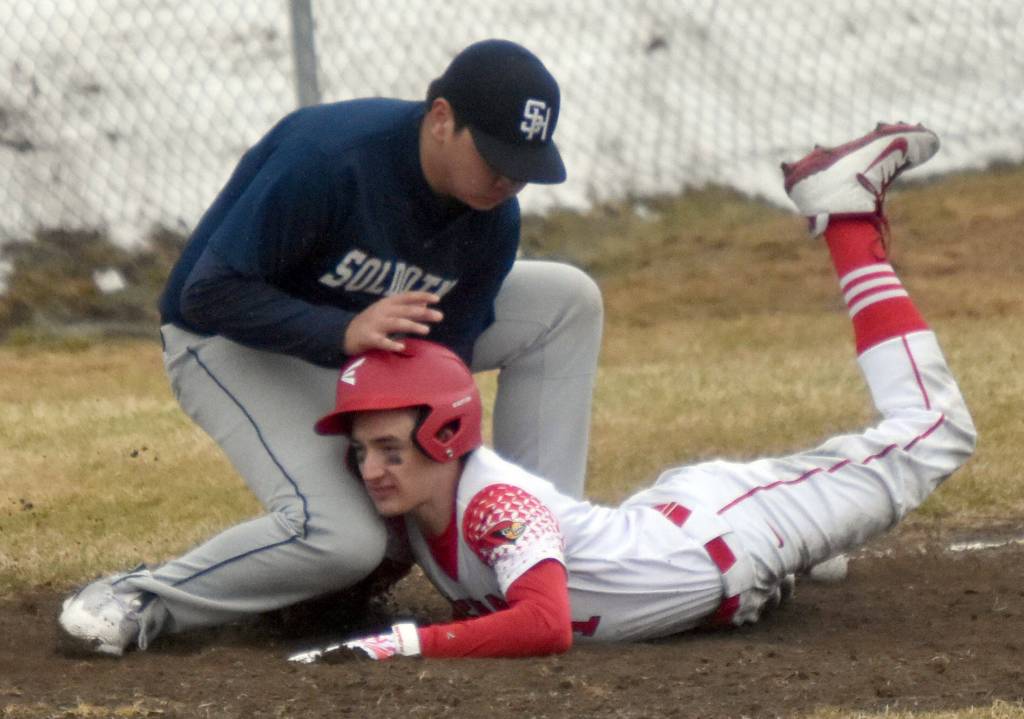 Soldotnas Sage Cruz tags out Kenai Centrals Owen Whicker on Tuesday, May 2, 2023, at the Kenai Little League Fields in Kenai, Alaska. (Photo by Jeff Helminiak/Peninsula Clarion)
