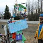 White Rainbow stands near his bike at a gas station on Wednesday, May 3, 2023 near Sterling, Alaska. (Ashlyn OHara/Peninsula Clarion)