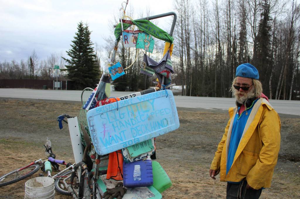 White Rainbow stands near his bike at a gas station on Wednesday, May 3, 2023 near Sterling, Alaska. (Ashlyn OHara/Peninsula Clarion)