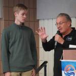 First Place Winner Paxton McKnight, of Cook Inlet Academy, is introduced by Merrill Sikorski at the Caring for the Kenai Awards Celebration held during a Joint Chamber Luncheon on Wednesday, May 3, 2023, at the Soldotna Regional Sports Complex in Soldotna, Alaska. (Jake Dye/Peninsula Clarion)