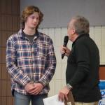 Matthew Schiling, of Cook Inlet Academy, is introduced by Merrill Sikorski at the Caring for the Kenai Awards Celebration held during a Joint Chamber Luncheon on Wednesday, May 3, 2023, at the Soldotna Regional Sports Complex in Soldotna, Alaska. (Jake Dye/Peninsula Clarion)