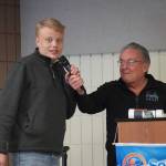 Liam Bartholomew, of Cook Inlet Academy, is introduced by Merrill Sikorski at the Caring for the Kenai Awards Celebration held during a Joint Chamber Luncheon on Wednesday, May 3, 2023, at the Soldotna Regional Sports Complex in Soldotna, Alaska. (Jake Dye/Peninsula Clarion)