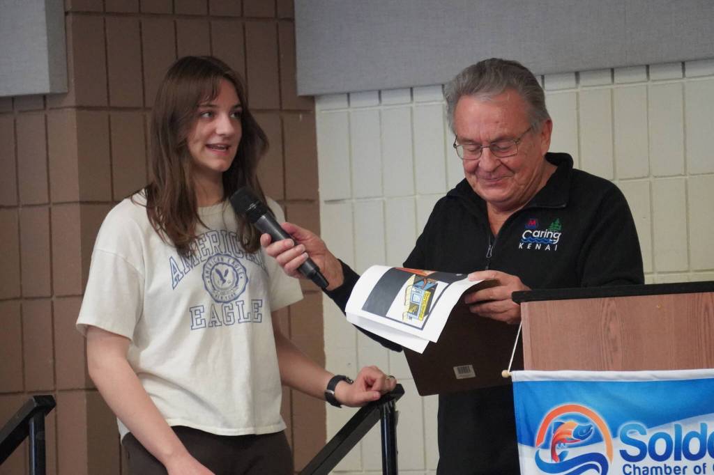 Runner-Up Nova Paulk, of Soldotna High School, is introduced by Merrill Sikorski at the Caring for the Kenai Awards Celebration held during a Joint Chamber Luncheon on Wednesday, May 3, 2023, at the Soldotna Regional Sports Complex in Soldotna, Alaska. (Jake Dye/Peninsula Clarion)