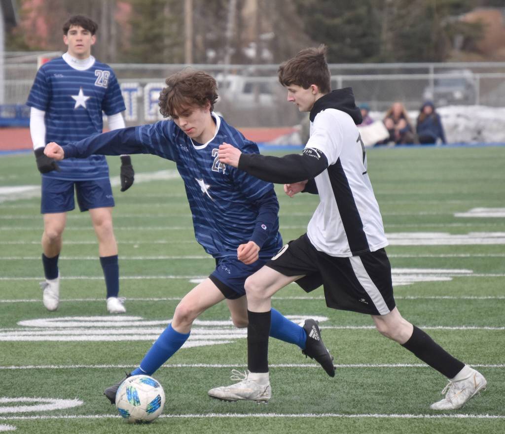 Soldotnas Liam Peck and Nikiskis Gavin Bullas battle for the ball Wednesday, May 3, 2023, at Justin Maile Field at Soldotna High School in Soldotna, Alaska. (Photo by Jeff Helminiak/Peninsula Clarion)