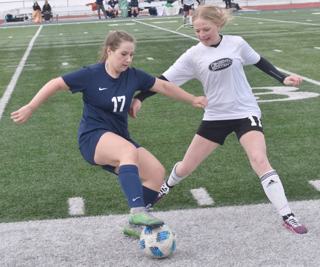 Soldotnas Liberty Miller shields the ball from Nikiskis Avery White on Wednesday, May 3, 2023, at Justin Maile Field at Soldotna High School in Soldotna, Alaska. (Photo by Jeff Helminiak/Peninsula Clarion)