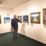 Curator Barnabas Firth tells stories of artworks by Norman Lowell to attendees of the invitational gathering on Saturday, April 29, 2023 at the Norman Lowell Art Gallery in Anchor Point, Alaska. Photo by Delcenia Cosman