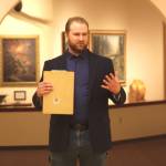 Curator Barnabas Firth welcomes attendees of the invitational gathering on Saturday, April 29, 2023 at the Norman Lowell Art Gallery in Anchor Point, Alaska. Photo by Delcenia Cosman