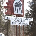 The newly-built sign for the Norman Lowell art gallery sits next to the Sterling Highway at the entrance of Norman Lowell Road between Homer and Anchor Point, Alaska. Photo by Delcenia Cosman