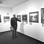 Curator Barnabas Firth tells stories of artworks by Norman Lowell to attendees of the invitational gathering on Saturday at the Norman Lowell Art Gallery in Anchor Point. Photo by Delcenia Cosman