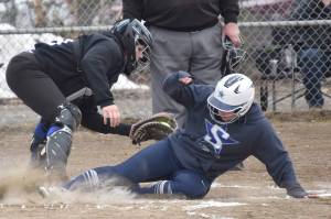 Soldotna's Kiara "KiKi" Forkner slides under the tag of Kodiak catcher Hailee Henslee on Saturday, May 6, 2023, at the Soldotna Little League fields in Soldotna, Alaska. (Photo by Jeff Helminiak/Peninsula Clarion)