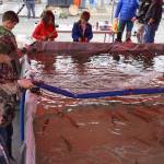 Children fish for rainbow trout at the Kenai Peninsula Sport, Rec & Trade Show on Saturday, May 6, 2023, at the Soldotna Regional Sports Complex in Soldotna, Alaska. (Jake Dye/Peninsula Clarion)