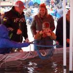 A young boy reels in a rainbow trout while another moves in with a net at the Kenai Peninsula Sport, Rec & Trade Show on Saturday, May 6, 2023, at the Soldotna Regional Sports Complex in Soldotna, Alaska. (Jake Dye/Peninsula Clarion)