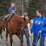 A young boy rides a horse at the Kenai Peninsula Sport, Rec & Trade Show on Saturday, May 6, 2023, at the Soldotna Regional Sports Complex in Soldotna, Alaska. (Jake Dye/Peninsula Clarion)