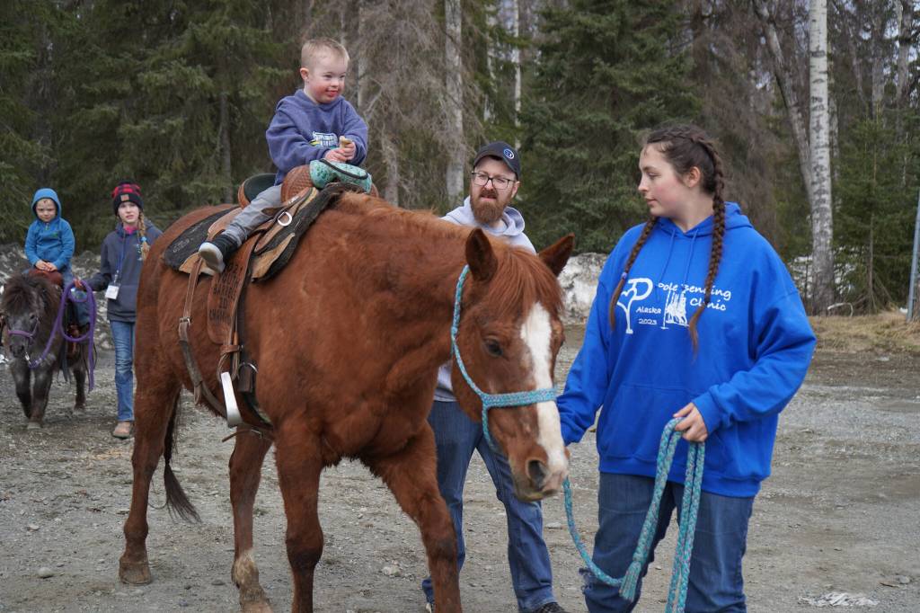 A young boy rides a horse at the Kenai Peninsula Sport, Rec & Trade Show on Saturday, May 6, 2023, at the Soldotna Regional Sports Complex in Soldotna, Alaska. (Jake Dye/Peninsula Clarion)