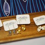 Ceramic earrings made by Michelle Carmichael are displayed at the Kenai Peninsula Sport, Rec & Trade Show on Saturday, May 6, 2023, at the Soldotna Regional Sports Complex in Soldotna, Alaska. (Jake Dye/Peninsula Clarion)