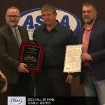 Tim Johnson, center, receives the award for his son Lincoln Johnson at the Alaska High School Hall of Fames Class of 2023 induction ceremony on Sunday, May 7, 2023, at The Lakefront Hotel in Anchorage, Alaska. Lincoln was an inductee of the Class of 2020. (Screenshot)