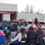 The Kenai Middle School Band performs in front of a crowd in winter jackets during Pops in the Parking Lot at Kenai Central High School in Kenai, Alaska, on Thursday, May 4, 2023. (Jake Dye/Peninsula Clarion)