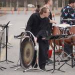 Kage Adkins strikes a gong during Pops in the Parking Lot at Kenai Central High School in Kenai, Alaska, on Thursday, May 4, 2023. (Jake Dye/Peninsula Clarion)