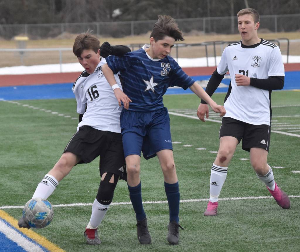 Kenai Centrals Sawyer Vann saves the ball in front of Soldotnas Lane Hillyer on Monday, May 8, 2023, at Justin Maile Field at Soldotna High School in Soldotna, Alaska. (Photo by Jeff Helminiak/Peninsula Clarion)