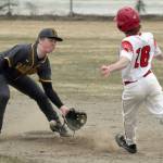 Kenai Central's Avery Martin arrives safely at second base in front of Homer second baseman Preston Stanislaw on Tuesday, May 9, 2023, at the Kenai Little League fields in Kenai, Alaska. (Photo by Jeff Helminiak/Peninsula Clarion)