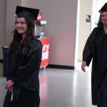Valerie Cazares, left, walks into the Renee C. Henderson Auditorium for Kenai Peninsula Colleges 53rd annual Commencement on Thursday, May 11, 2023, in Kenai, Alaska. (Jake Dye/Peninsula Clarion)