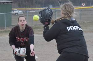 Kenai Central first baseman Izzie Katzenberger shovels to second baseman Shelby Hemphill for an out against Houston on Thursday, May 11, 2023, at the Steve Shearer Memorial Ball Park in Kenai, Alaska. (Photo by Jeff Helminiak/Peninsula Clarion)