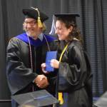 Kachemak Bay Campus Director Dr. Reid Brewer (left) presents valedictorian Elizabeth Rozeboom (right) with her Associate of Arts diploma during the 2023 KBC Commencement on Wednesday, May 10, 2023, in Homer, Alaska. (Photo by Delcenia Cosman/Homer News)