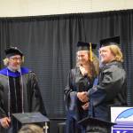 Tanner Saulls (right) is awarded his high school equivalency diploma by Kachemak Bay Campus Adult Education Coordinator Michelle Waclawski (center) during the 2023 KBC Commencement on Wednesday, May 10, 2023, in Homer, Alaska. (Photo by Delcenia Cosman/Homer News)