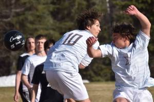Soldotna's Daniel Heath and Johnny Wardas try to head the ball in Nikiski's goal Friday, May 12, 2023, at Nikiski High School in Nikiski, Alaska. (Photo by Jeff Helminiak/Peninsula Clarion)