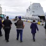 Lt. j.g. William Ash leads Deputy Police Chief Karl Schaefermeyer, Harbormaster/Acting City Manager Norm Regis and Seward Mayor Sue McClure to the USS Zumwalt on Friday, May 12, 2023, in Seward, Alaska. (Jake Dye/Peninsula Clarion)