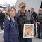 Seward Mayor Sue McClure presents Capt. Matthew Hall of the USS Zumwalt with a plaque commemorating their first voyage to the port on Friday, May 12, 2023, in Seward, Alaska. (Jake Dye/Peninsula Clarion)