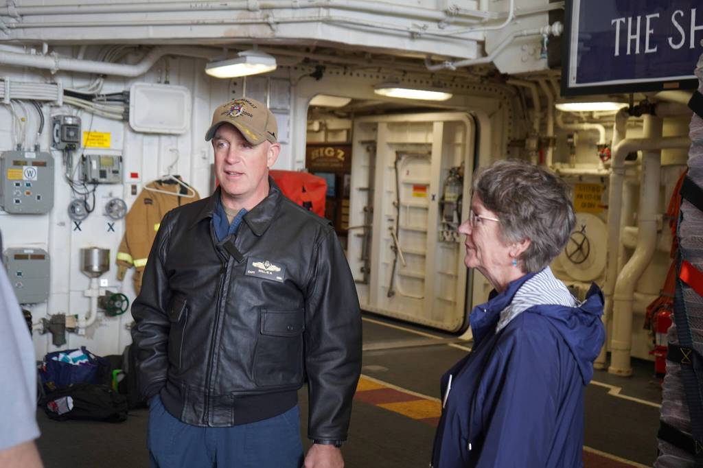 Capt. Matthew Hall leads Seward Mayor Sue McClure on a tour of the USS Zumwalt in Seward, Alaska, on Friday, May 12, 2023. (Jake Dye/Peninsula Clarion)