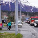 Seward residents gather along 4th Avenue in Seward, Alaska to see a parade of Seward High School seniors on Friday, May 12, 2023. (Jake Dye/Peninsula Clarion)