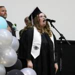 Nikiski Middle/High School graduate Adrienne Muir sings the national anthem during a ceremony on Tuesday, May 16, 2023, in Nikiski, Alaska. (Ashlyn OHara/Peninsula Clarion)