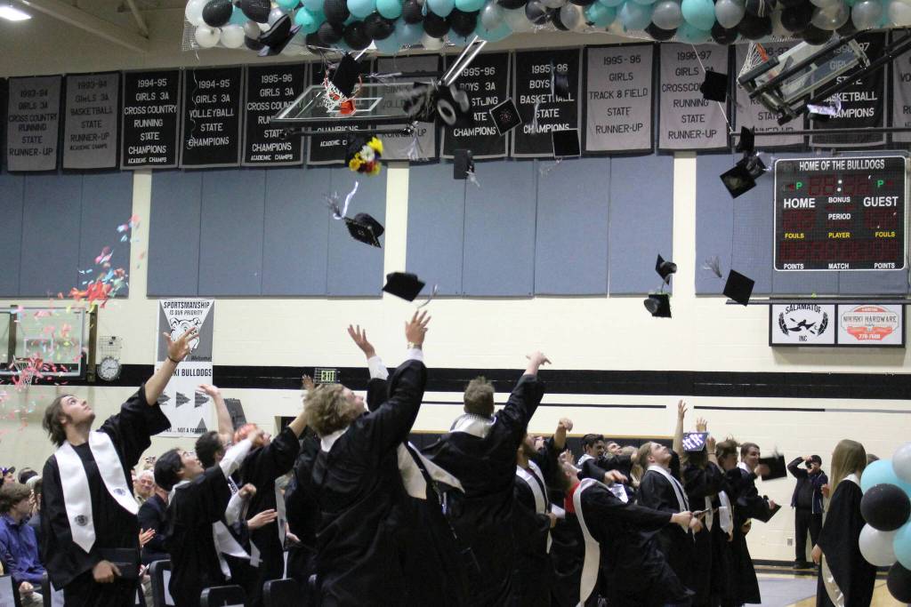 Nikiski Middle/High School graduates toss their caps during a ceremony on Tuesday, May 16, 2023 in Nikiski, Alaska. (Ashlyn OHara/Peninsula Clarion)