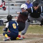 Kenai Centrals Kyana Griskevich scores in front of Homers Ariana Davis on Tuesday, May 16, 2023, at Steve Shearer Memorial Ball Park in Kenai, Alaska. (Photo by Jeff Helminiak/Peninsula Clarion)