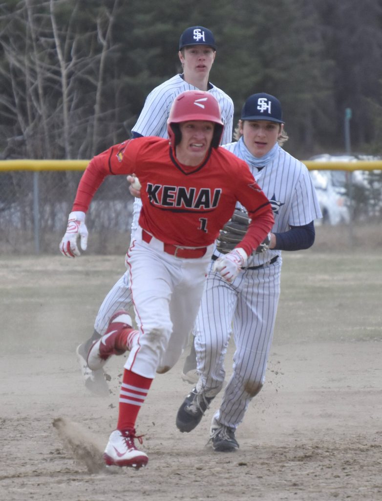 Kenai Centrals Owen Whicker runs away from Soldotna second baseman Trenton Ohnemus on Tuesday, May 16, 2023, at the Soldotna Little League fields in Soldotna, Alaska. (Photo by Jeff Helminiak/Peninsula Clarion)