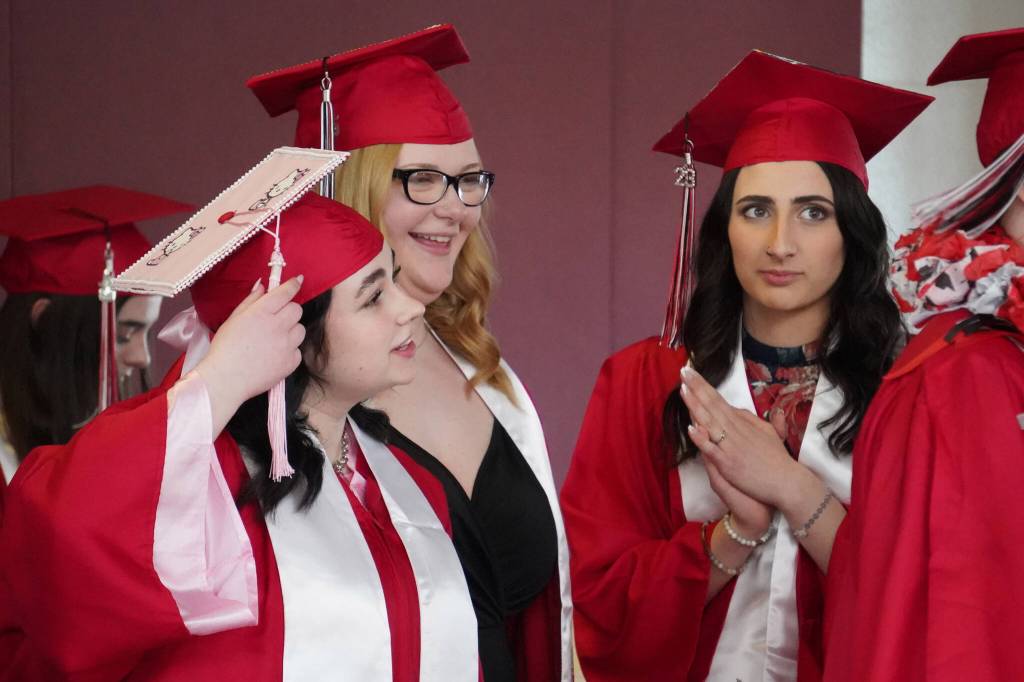 Kenai Central High School graduates prepare to enter the auditorium for their graduation ceremony on Wednesday, May 17, 2023, at Kenai Central High School in Kenai, Alaska. (Jake Dye/Peninsula Clarion)