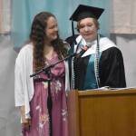 River City Academy graduate Hannah Crabtree gives an address with her mother, Annie Crabtree, by her side. Hannah won so many awards and scholarships that she was directed to take a seat onstage instead of continually returning to her seat. I owe everything to my mom, Hannah said. All those fancy awards was because she helped me get there. (Photo by Jeff Helminiak/Peninsula Clarion)