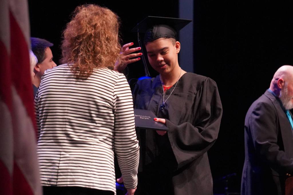 Connections Homeschool students take the stage to receive their diplomas during the Connections Homeschool graduation ceremony on Thursday, May 18, 2023, at Soldotna High School in Soldotna, Alaska. (Jake Dye/Peninsula Clarion)