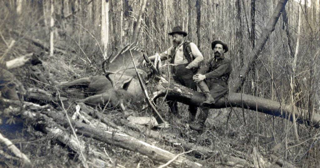 Photo #606.1.4 courtesy of the Resurrection Bay Historical Society
Skilled hunter John A. Baughman (L) and an unidentified man pose on the Kenai Peninsula with a large bull moose kill in about 1910.