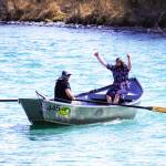 Contestants celebrate after completing the 16th Annual Cooper Landing Drift Boat Regatta at Sportsmans Landing in Cooper Landing, Alaska, on Saturday, May 20, 2023. (Jake Dye/Peninsula Clarion)
