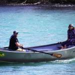 Contestants celebrate after completing the 16th Annual Cooper Landing Drift Boat Regatta at Sportsmans Landing in Cooper Landing, Alaska, on Saturday, May 20, 2023. (Jake Dye/Peninsula Clarion)