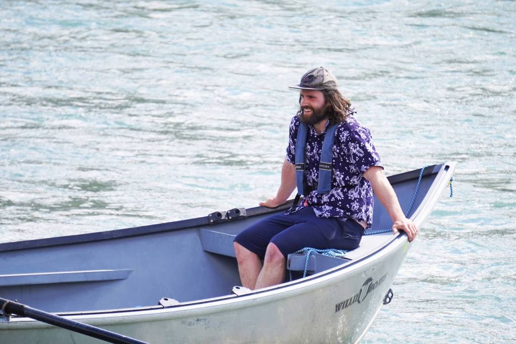 Contestants celebrate after completing the 16th Annual Cooper Landing Drift Boat Regatta at Sportsmans Landing in Cooper Landing, Alaska, on Saturday, May 20, 2023. (Jake Dye/Peninsula Clarion)