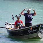 Contestants celebrate after completing the 16th Annual Cooper Landing Drift Boat Regatta at Sportsmans Landing in Cooper Landing, Alaska, on Saturday, May 20, 2023. (Jake Dye/Peninsula Clarion)