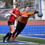 Homer goalie Felicia Weisser pushes a shot wide in front of Kenai Centrals Kori Moore on Saturday, May 20, 2023, in the championship game of the Peninsula Conference tournament at Justin Maile Field at Soldotna High School in Soldotna, Alaska. (Photo by Jeff Helminiak/Peninsula Clarion)