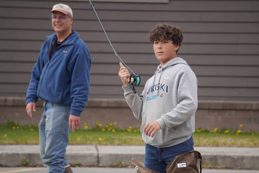Middle schoolers practice fly casting in the parking lot of the Donald E. Gilman Kenai River Center in Soldotna, Alaska, during a kids camp put on by Trout Unlimited on Wednesday, May 24, 2023. (Jake Dye/Peninsula Clarion)