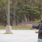 Ethan Anderson practices fly casting in the parking lot of the Donald E. Gilman Kenai River Center in Soldotna, Alaska, during a kids camp put on by Trout Unlimited on Wednesday, May 24, 2023. (Jake Dye/Peninsula Clarion)